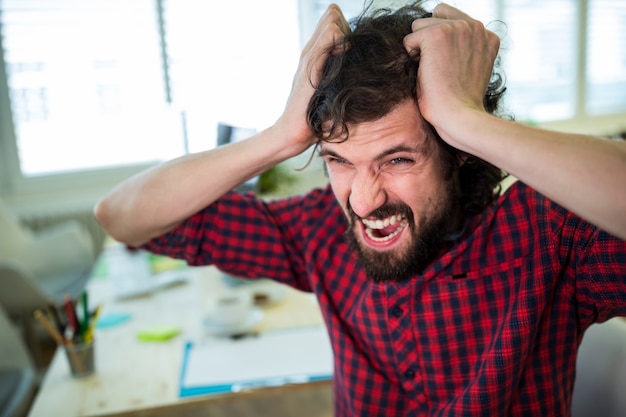 Free photo frustrated male graphic designer in office