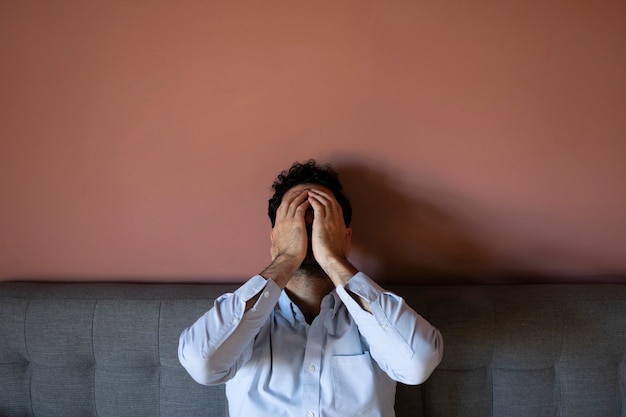 Frustrated man on couch front view