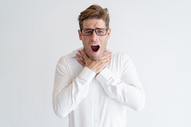 Frustrated man showing suffocation gesture