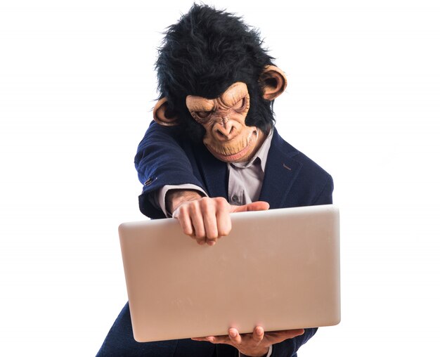 Frustrated monkey man holding a laptop