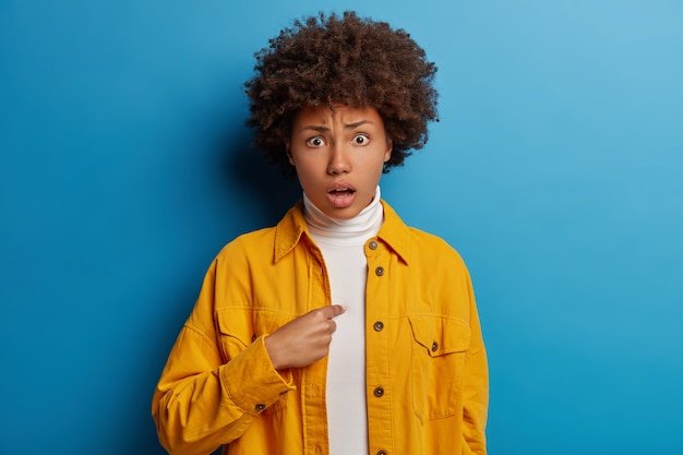 Frustrated shocked indignant woman points at herself, being accused of something, feels worried and disturbed as not want to be involved in something