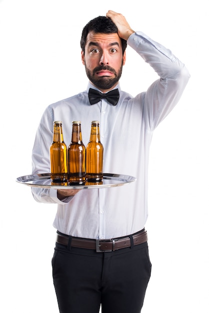 frustrated waiter with beer bottles on the tray