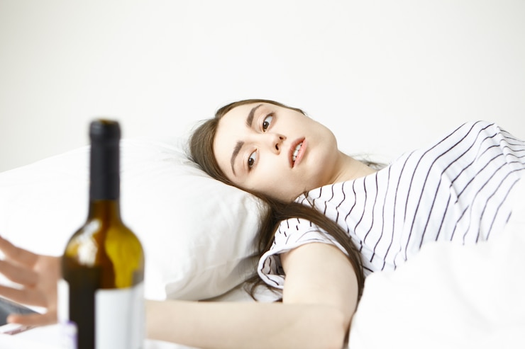 Free Photo frustrated young woman having heavy morning, awakened early in her bed after party, feeling unwell and depressed, suffering from hangover