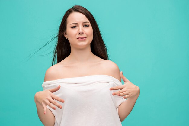 Frustrated young woman posing on blue