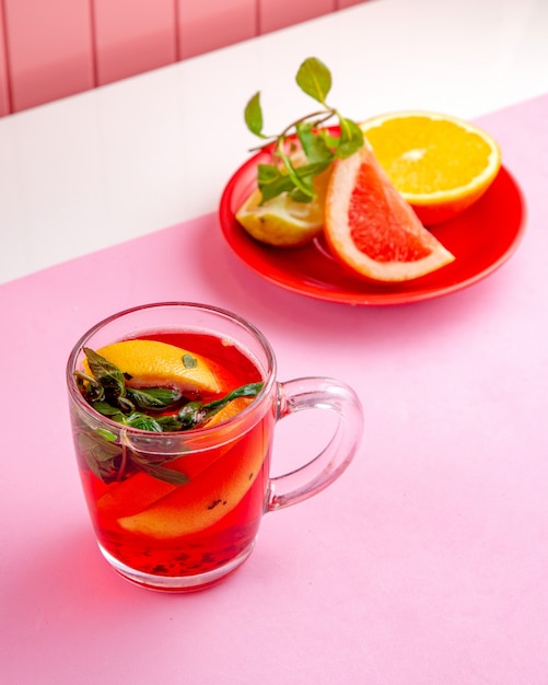 frut te with lemon orange mint and grapefruit on table