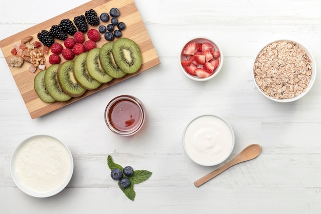 Fruts with yougurt and granola on table