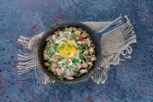 A frying pan of omelet with vegetables . 