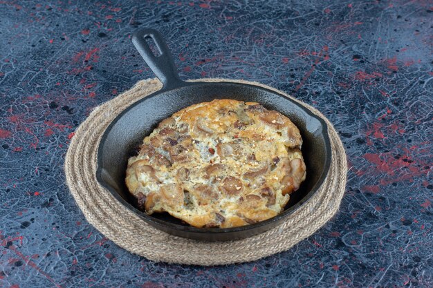 A frying pan of omelet with vegetables 