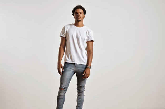 Full-body portrait of an athletic young male in ripped light blue jeans and blank white shortsleeve t-shirt