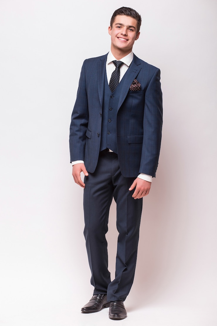 Free Photo full body portrait of a businessman in suit standing on isolated white wall