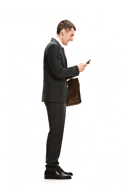 Full body portrait of businessman with briefcase on white