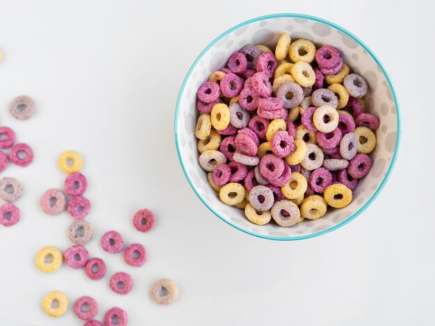 Full bowl of fruit cereal loops on white background