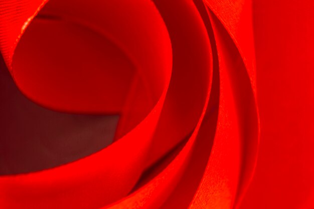 Full frame of curved red satin ribbon