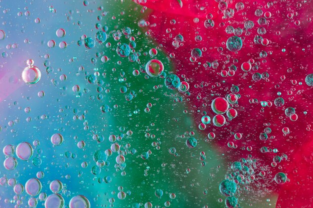 Full frame shot of oil bubbles floating on multi colored background