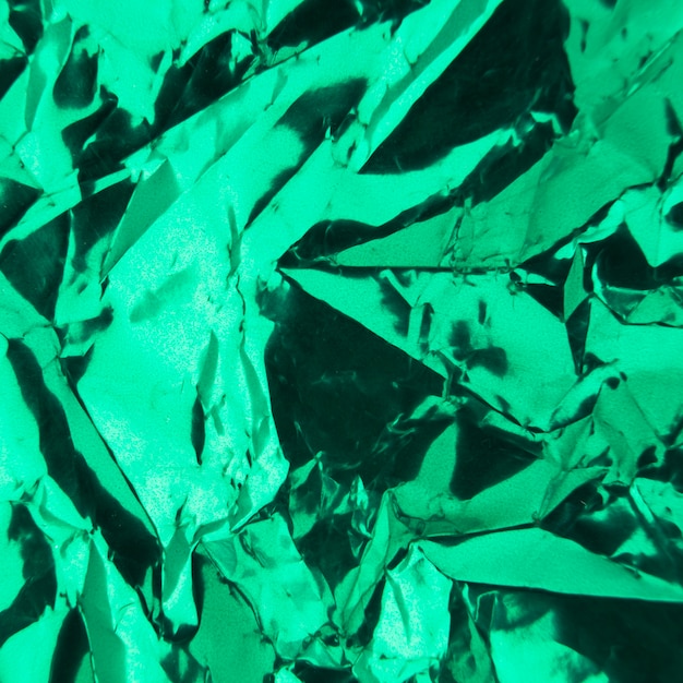 Full frame of wrinkled wrapped green paper