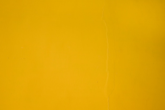 Полный кадр желтого текстурированной стены фон
