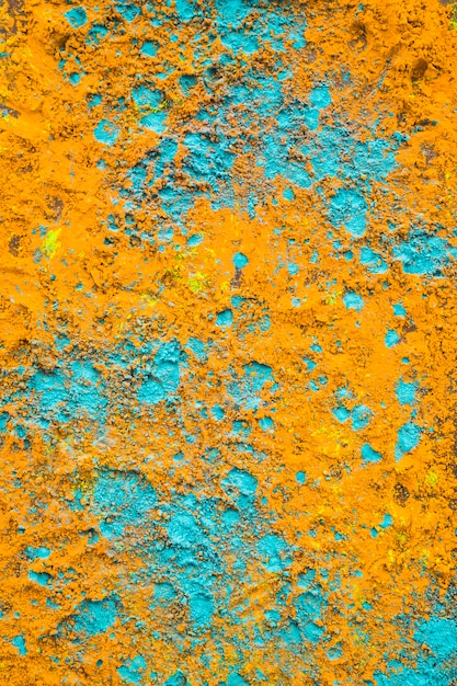 Full frame of yellow and turquoise holi powder