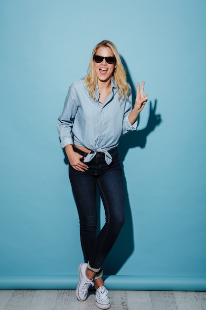 Full length Happy woman in shirt and sunglasses