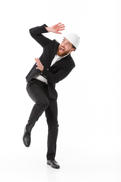 Full length image of Scared business man in protective helmet