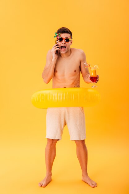 Full-length image of Screaming naked man in shorts and sunglasses