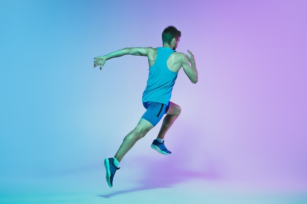 Full length portrait of active young caucasian running, jogging man