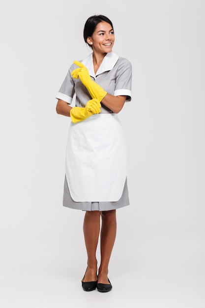 Full length portrait of a attractive smiling housekeeper