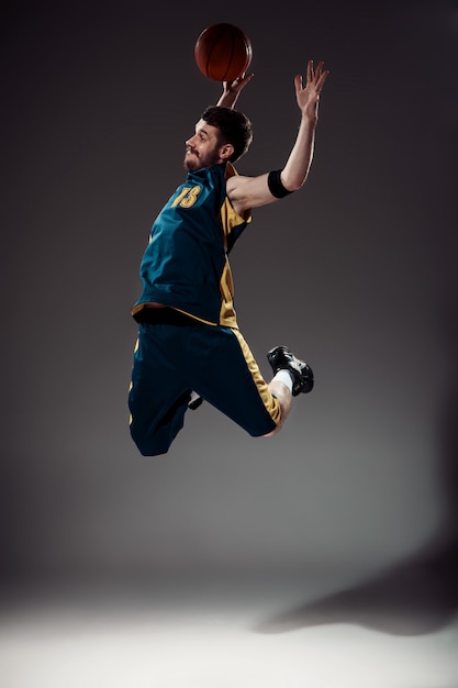 Full length portrait of a basketball player with ball