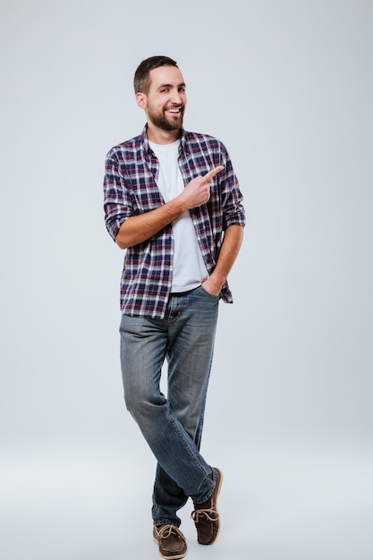 Full length portrait of Bearded man in shirt pointing away