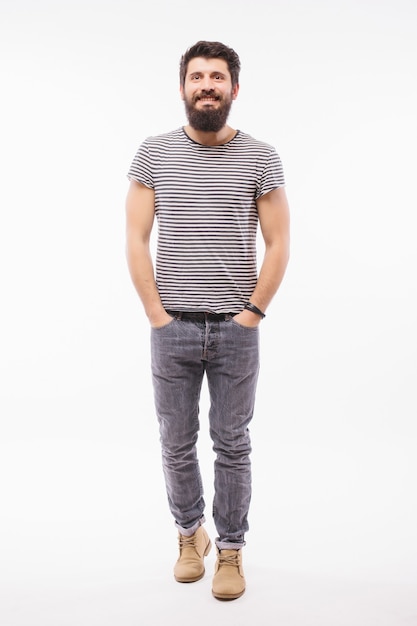 Free photo full length portrait of bearded man in shirt with arm in pocket which pointing away.