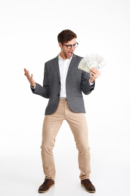 Free photo full length portrait of cheerful excited man in eyeglasses