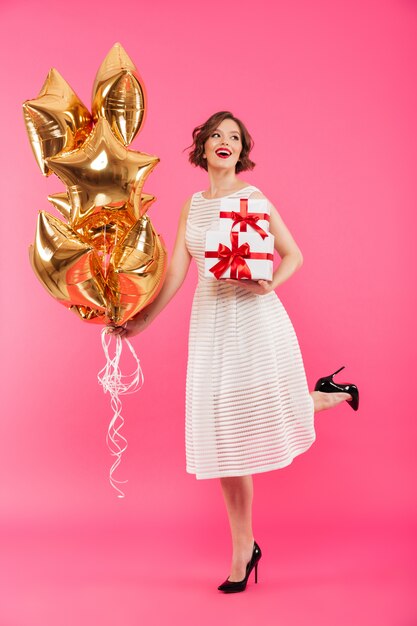 Full length portrait of a cheerful girl dressed in dress