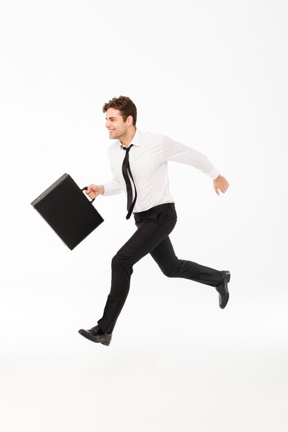 Full length portrait of a cheerful handsome businessman