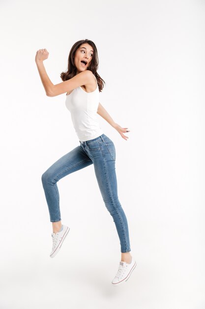 Full length portrait of a cheerful woman