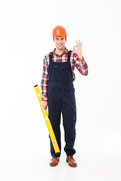 Full length portrait of a cheerful young male builder