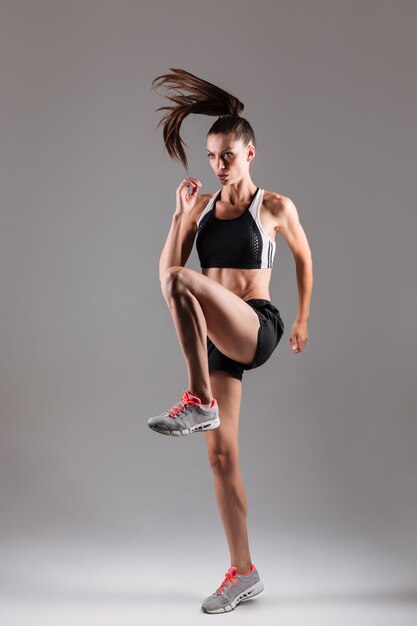 Full length portrait of a concentrated fit sportswoman