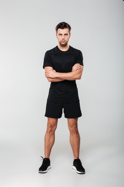 Full length portrait of a concentrated young sportsman
