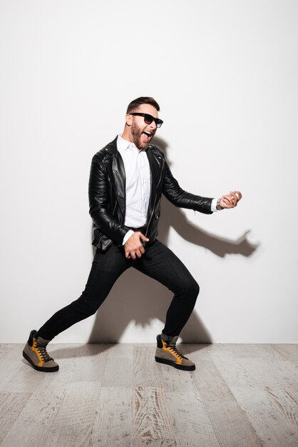 Full length portrait of an excited young man