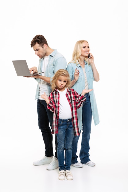 Full length portrait of a family talking on mobile phone