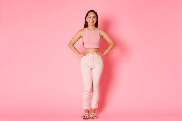 Full length portrait of fashionable brunette asian girl standing