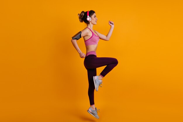 Full-length portrait of female model doing cardio