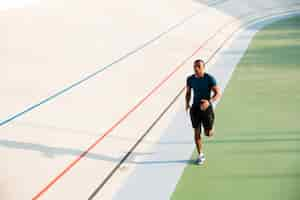 Free photo full length portrait of a fit young sportsman running