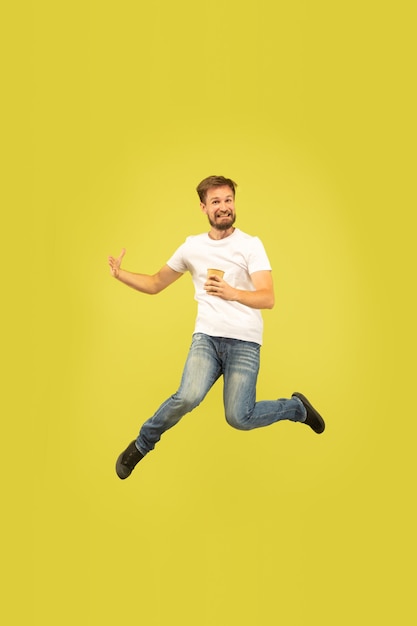 Full length portrait of happy jumping man