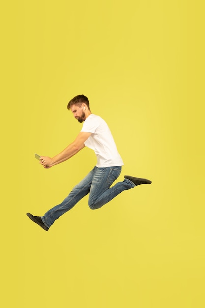 Full length portrait of happy jumping man