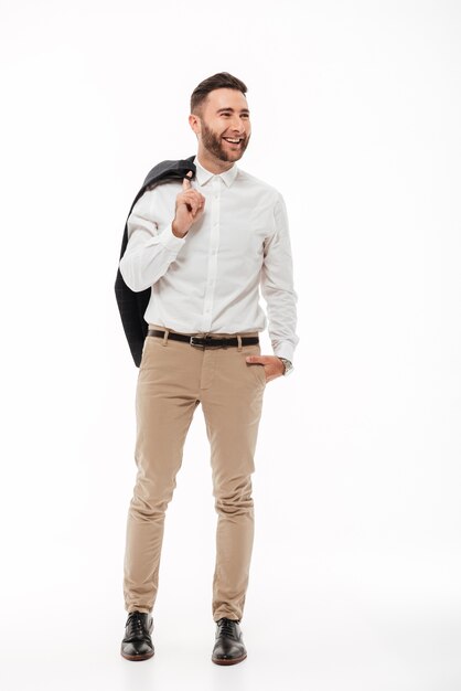 Full length portrait of a happy young man holding jacket