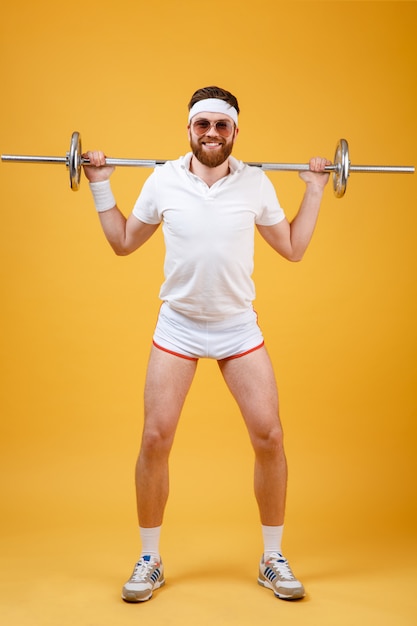 Free photo full length portrait of a man athlete exercising with barbell
