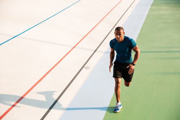 Full length portrait of a muscular sportsman running
