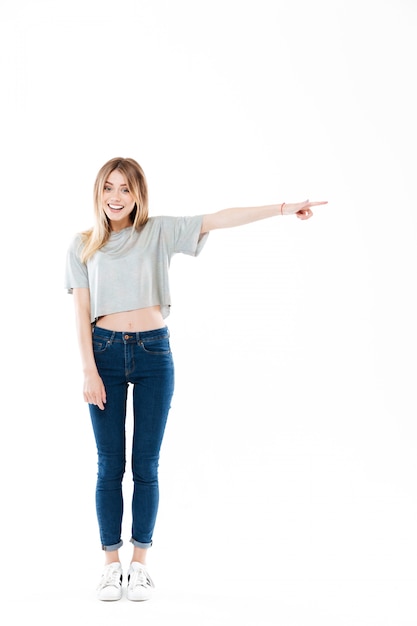 Full length portrait of a pretty casual young woman standing