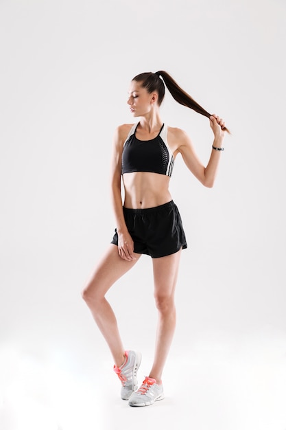 Full length portrait of a pretty young sportswoman posing