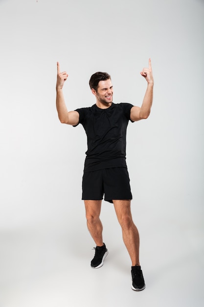 Full length portrait of a satisfied young sportsman celebrating