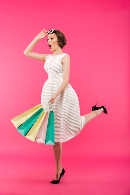 Full length portrait of a shocked girl dressed in dress